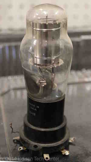 Why do electrons cross the gap in a vacuum tube?